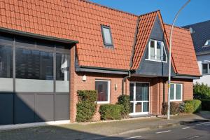 a red brick house with an orange roof at Die Alter Schwede Wohnung 2 in Vechta
