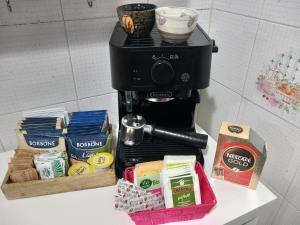 a coffee maker sitting on top of a counter with food at La Casa di Gio ed Eli in Voghera
