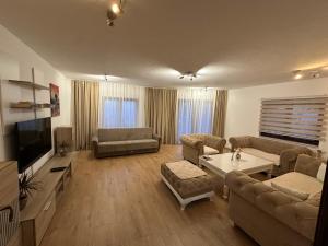a living room with a couch and a tv at Apartmani Dalija in Sarajevo