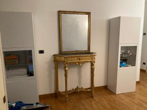 a mirror on top of a table in a room at Residenza Palazzo Jona in Ancona