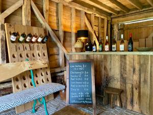 a room with bottles of wine and a sign at Potts Farm in Tenterden