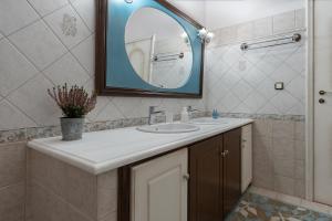 a bathroom with a sink and a mirror at Amara Haven in Aígio +13 photos