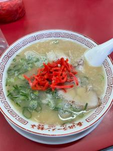 a bowl of soup on a table with a spoon at Docaホテル セルフチェックイン in Fukuoka