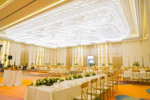 ネゴンボにあるGrandeeza Hotel by Galisonの白いテーブルと椅子が備わる宴会場