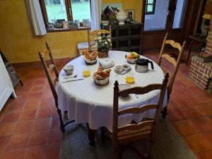 a table with a white table cloth and food on it at BERNAY Chambre avec Salon, salle d'eau privative et entrée indépendante in Bernay