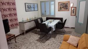 a living room with a dining room table and chairs at Affittacamere Casa Chiara in SantʼAntìoco