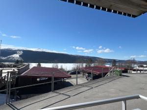 a building with two red roofs and a snow covered mountain at Perfect location ski-in Åre in Åre
