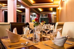 a table in a restaurant with glasses and napkins at Hadassah Hotel in Nairobi