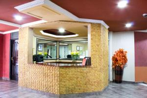 a brick wall with a mirror in a lobby at Hadassah Hotel in Nairobi