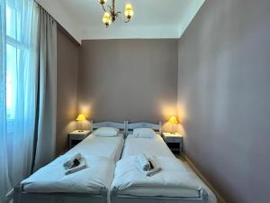 Posteľ alebo postele v izbe v ubytovaní Tinion Urban Hotel