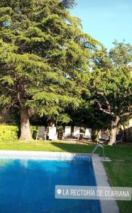 a swimming pool with lounge chairs and a tree at Casa con Piscina 1hr Barcelona in Jorba