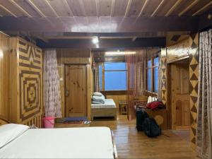 a bedroom with a bed and a room with a window at The Heritage, Sarahan in Sarāhan