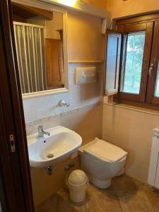 a bathroom with a sink and a toilet at Masseria Rosella - Longhi in Pietrelcina +19 photos