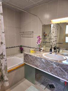 a bathroom with a sink and a tub and a mirror at Ocean Pearl Villa in Anse Royale +45 photos