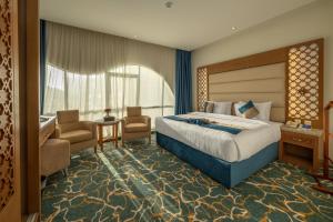 a hotel room with a bed and a desk and chair at Le Beaurivage Hotel in Jeddah