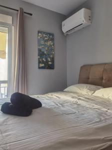 a bed with a pillow on it in a bedroom at 70m 2BR bright luxury apt in Athens