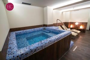 a jacuzzi tub in the middle of a room at Central Hotel, Fitness and Spa in Vinica
