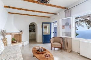 a living room with a table and a blue door at Villa Eleni - At the Top! in Apróvaton