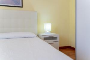 A bed or beds in a room at Apartments via Spano