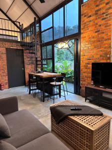 a living room with a couch and a table at BRIC by The Hectar Private Pool Villa Janda Baik in Bentong