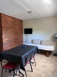 a room with a table with chairs and a bed at Casa Nuova - Depto SEIS in Villa Nueva