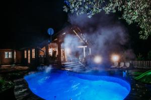 a pool at night with smoke coming out of it at Obidza 438 chata w górach in Obidza