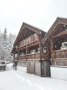 a wooden house covered in snow in the snow at Obidza 438 chata w górach in Obidza