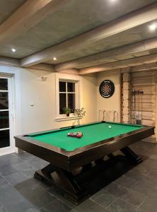 a pool table in a living room with afits at Obidza 438 chata w górach in Obidza