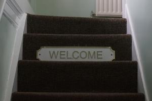 a set of stairs with a welcome sign on them at The Barford Inn in Salisbury