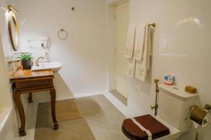 a bathroom with a sink and a toilet at Castle Hill Bungalow by Seven Angels in Kandy +81 photos