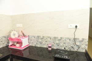 a kitchen counter with a phone on a counter top at Sai Homestay Panaji 2 BHK, 1 BHK and Studio Apartment in Panaji +23 photos