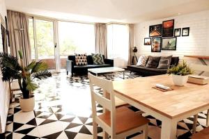a living room with a table and a couch at El Arbol by Da Alohas Luxury 2BHK suite Candolim in Nerul