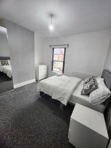 a bedroom with a bed and a window at Manor House walsall 2 in Walsall