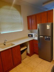 a kitchen with a refrigerator and a sink at شقه مفروشه دوبلكس من غرفتين نوم حى العليا الخبر in Al Khobar