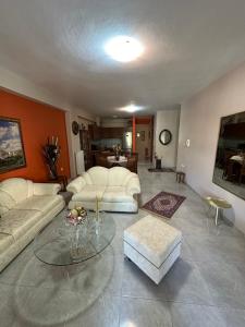 a living room with two couches and a table at Athina in Nea Peramos