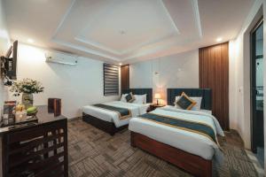 Postel nebo postele na pokoji v ubytování Central Sapa March Hotel