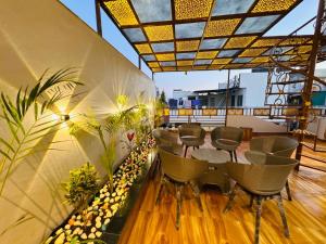 a patio with a table and chairs on a balcony at Shrilok Kutir 1BHK Penthouse in Ujjain