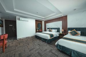 Postel nebo postele na pokoji v ubytování Central Sapa March Hotel