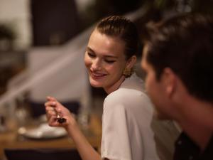 a woman looking at a man holding a ring at Hotel St.John Suites Adults Only in Tsilivi