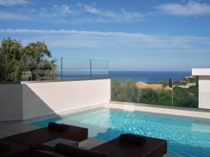 a swimming pool with a view of the ocean at Hotel St.John Suites Adults Only in Tsilivi