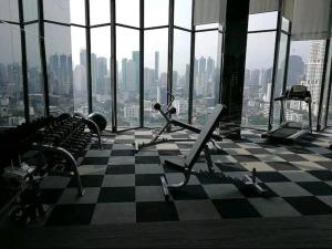 a gym with a checkered floor and views of a city at Upscale Apartment With Train Access Bts Thonglor in Bangkok +6 photos