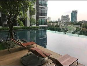 a couple of chairs sitting on top of a building at Upscale Apartment With Train Access Bts Thonglor in Bangkok