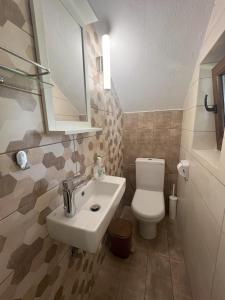 a bathroom with a sink and a toilet at DoorMat #20 Beach house Mikiverna in Kalyves Poligirou