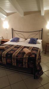 a bedroom with a large bed with blue pillows at Casa Del Sole in Pescara