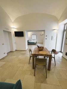 a living room with a wooden table and chairs at Casa Console in Conca dei Marini