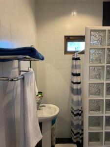 a bathroom with a sink and a shower curtain at Thailand Dream Village E09 in Klaeng