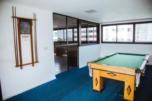 a office with a pool table in a room at Apartamentos na Orla da Pajuçara in Maceió
