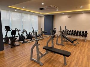 a gym with several treadmills and exercise bikes at Tulip Garden condo in Biñan