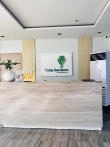 a large wooden counter in a room with a sign at Tulip Garden condo in Biñan +16 photos