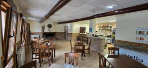 a restaurant with wooden tables and chairs and a bar at El Mirador de Tanes in Tanes